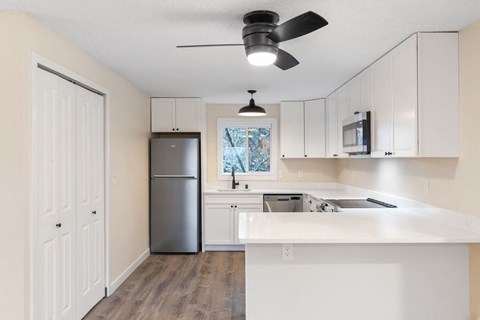 The Reserve at Bucklin Hill Apartments  kitchen with white cabinets and a stainless steel refrigerator